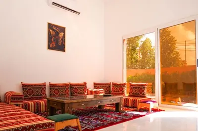 a room with a table and chairs and a window at Marrakesh Villa 1 in Marrakech