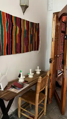 a room with a wooden table with a telephone at Riad EL BADIS in Marrakech