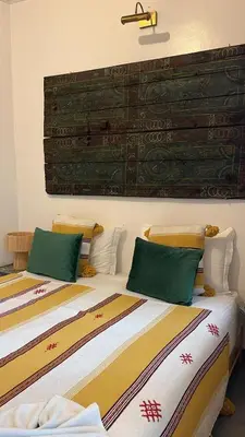 two beds sitting next to each other in a room at Riad EL BADIS in Marrakech