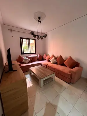 a living room with a couch and a table at Cosy urbain in Marrakech