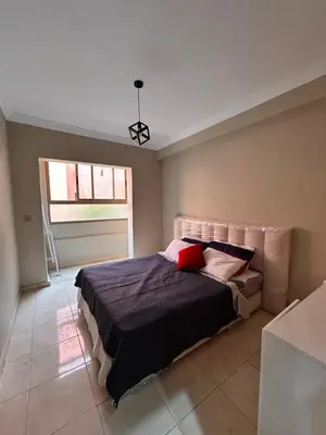 a bedroom with a bed and a window at Cosy urbain in Marrakech