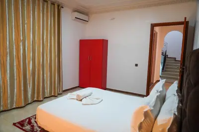 a bedroom with a bed and a red cabinet at Marrakesh villa 1 in Marrakech