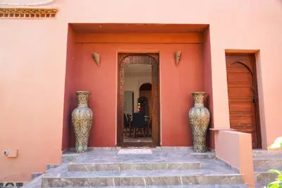 two large vases sitting on the side of a building at Marrakesh villa 1 in Marrakech