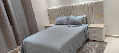 a small bedroom with a bed with blue sheets and pillows at Dar lala soukaina in Marrakech
