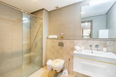 a bathroom with a shower and a toilet and a sink at Marguerite de Guéliz Piscine & Parking in Marrakech