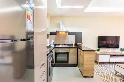 a kitchen with a stove and a counter top at Marguerite de Guéliz Piscine & Parking in Marrakech