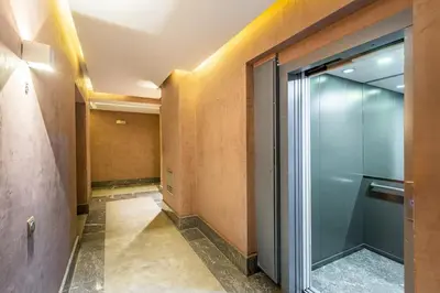 an empty hallway with a glass door in a building at Marguerite de Guéliz Piscine & Parking in Marrakech