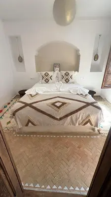 a bedroom with a large bed in a room at Riad 2 Ksour Marrakesh in Marrakech