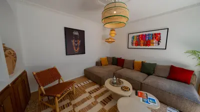 a living room with a couch and a table at Riad 2 Ksour Marrakesh in Marrakech
