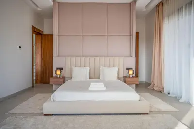a bedroom with a large white bed and two lamps at Villa Bahia Luxury-Pool Breakfast & Golf Access in Marrakech