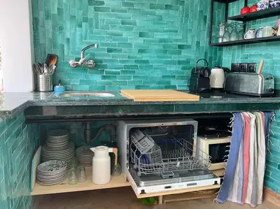a kitchen with a counter with a microwave and a sink at Riad zouine dans un quartier traditionnel in Marrakech
