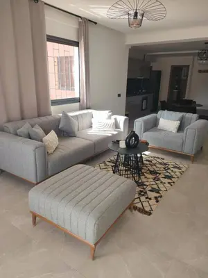 a living room with two couches and a coffee table at Appartement à Guéliz avec belle terrasse in Marrakech