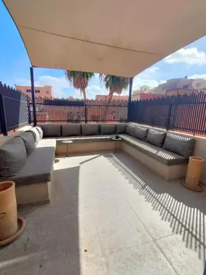 a large couch sitting on top of a patio at Appartement à Guéliz avec belle terrasse in Marrakech