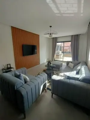 a living room with two couches and a tv at Appartement à Guéliz avec belle terrasse in Marrakech