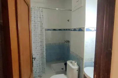 a bathroom with a toilet and a sink and a shower at Appartement familial in Marrakech