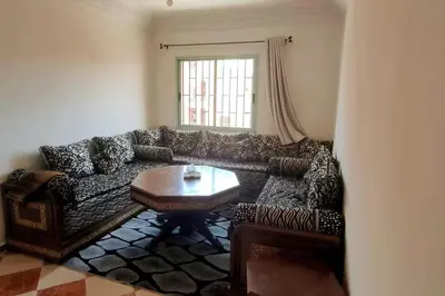 a living room with a couch and a table at Appartement familial in Marrakech