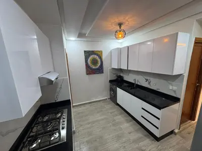 a kitchen with white cabinets and a stove top oven at Apartment in Marrakech in Marrakech