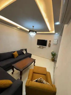 a living room with a couch and a table and a tv at Apartment in Marrakech in Marrakech