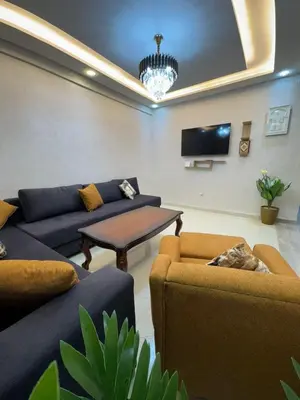 a living room with couches and a flat screen tv at Apartment in Marrakech in Marrakech