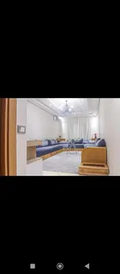 a living room with a couch and a bed at Appartement DUPLEX in Marrakech