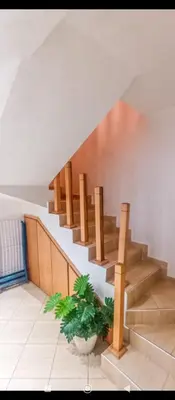 a staircase in a house with a plant next to it at Appartement DUPLEX in Marrakech