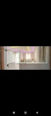 a picture of a living room with a room with at Appartement DUPLEX in Marrakech