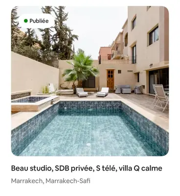 a swimming pool in front of a house at Studio avec SDB salon tele kitchenette privé dans une villa piscine, calme et commodités in Marrakech