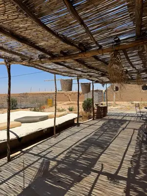 a wooden patio with a view of the desert at Farm stay in Marrakech