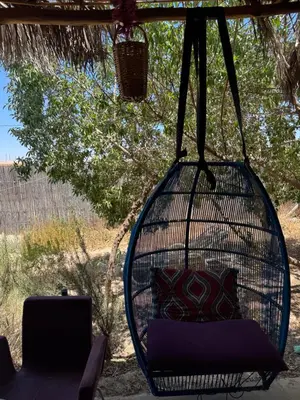 a hanging hammock with a couch and a laptop at Farm stay in Marrakech