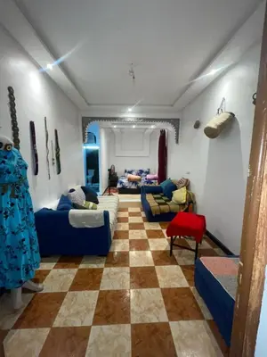a living room with couches and a checkered floor at Suite 2 in Marrakech