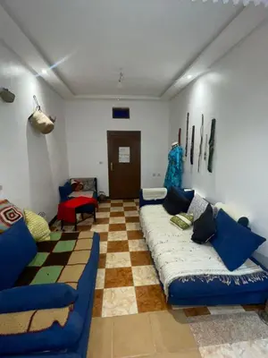 a living room with a couch and a checkered floor at Suite 2 in Marrakech
