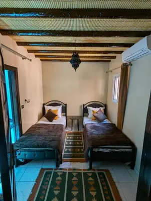a bedroom with two beds in a room at Riad du village in Marrakech