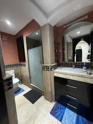 a bathroom with a shower and a sink and a toilet at Luxury Gueliz Apartment-Miramas 2 in Marrakech