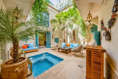 a house with a swimming pool in a yard at Riad Dar Palma Heated Pool Jacuzzi Heart Of Marrakech Medina in Marrakech