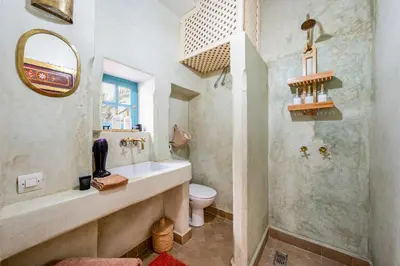 a bathroom with a sink and a toilet at Riad Dar Palma Heated Pool Jacuzzi Heart Of Marrakech Medina in Marrakech