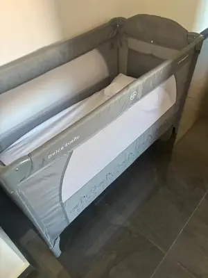 a metal bunk bed with white sheets on it at Chic Duplex Central 3 Suites et Wi-Fi in Marrakech