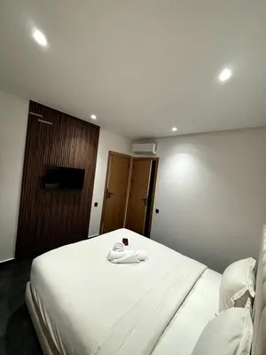 a hotel room with a bed with a robe on it at Chic Duplex Central 3 Suites et Wi-Fi in Marrakech
