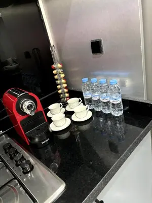 a kitchen counter with bottles of water on it at Chic Duplex Central 3 Suites et Wi-Fi in Marrakech