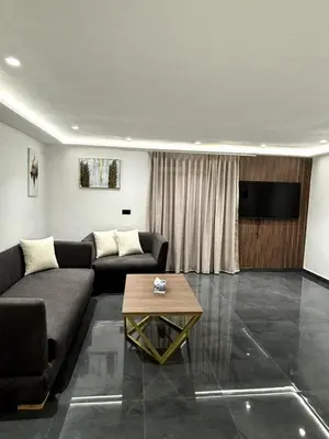 a living room with a couch and a television at Chic Duplex Central 3 Suites et Wi-Fi in Marrakech