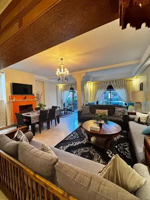 a living room with a couch and a table at Dar Fayz in Marrakech