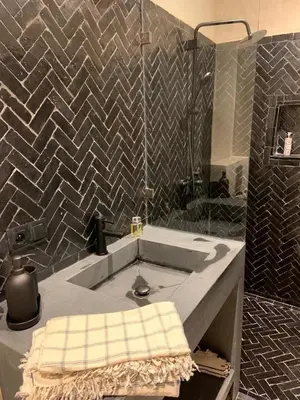 a bathroom with a sink and a shower at Riad Daba Chic in Marrakech