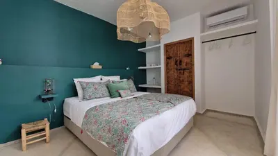 a bedroom with a bed and a blue wall at Riad Daba Chic in Marrakech