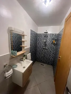 a bathroom with a sink and a shower at Brand new cozy apartment in Marrakech