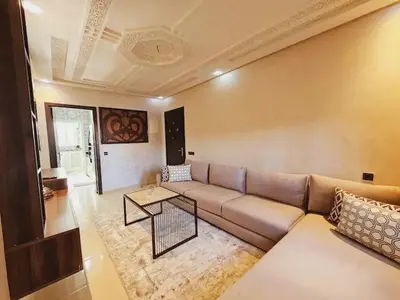 a living room with a couch and a table at Luxurious and charming apartment in Marrakech