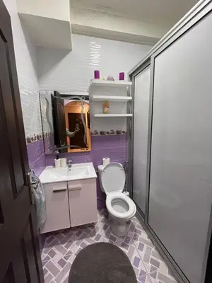 a purple bathroom with a toilet and a sink at Luxurious and charming apartment in Marrakech