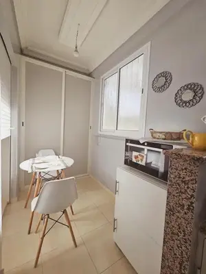 a kitchen with a table and a table and a table at Luxurious and charming apartment in Marrakech