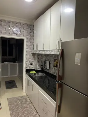 a kitchen with white cabinets and a stainless steel refrigerator at Luxurious and charming apartment in Marrakech
