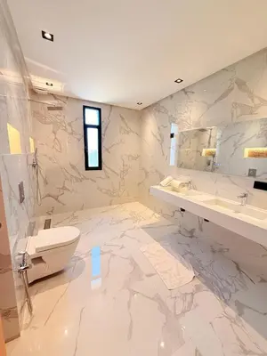 a marble bathroom with a toilet and a sink at Villa privée in Marrakech