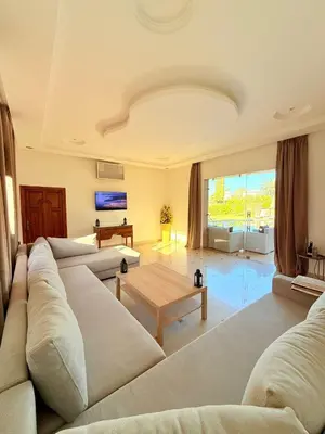 a living room with a couch and a table at Villa privée in Marrakech