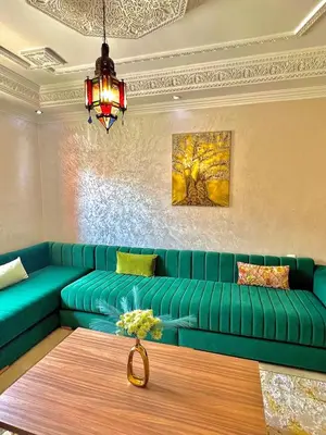 a green couch in a living room with a table at Marrakech home in Marrakech